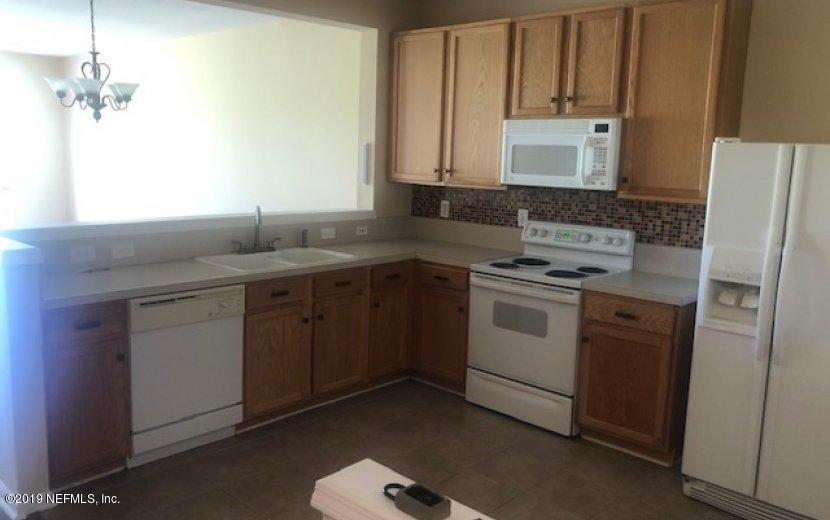 7990 Baymeadows Road, Unit E#2405 Jacksonville, FL 32256 - Photo 6 of 14 a kitchen with a sink stove and refrigerator