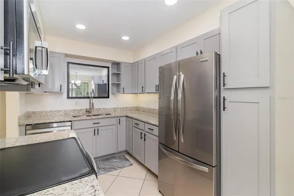 an empty room with white cabinet and a ceiling fan