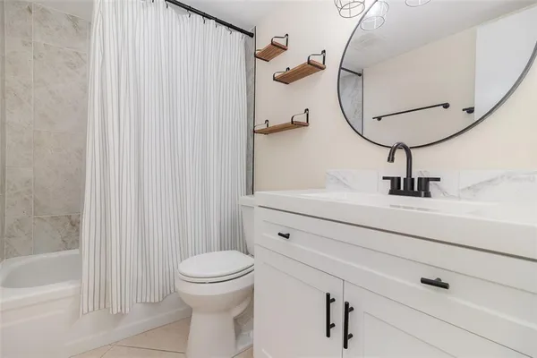 an empty room with closet and a ceiling fan