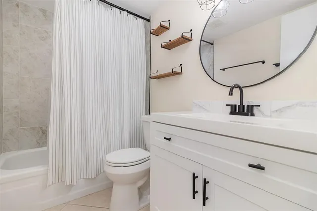 an empty room with closet and a ceiling fan