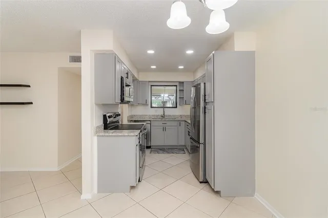 a kitchen with stainless steel appliances granite countertop a sink and cabinets