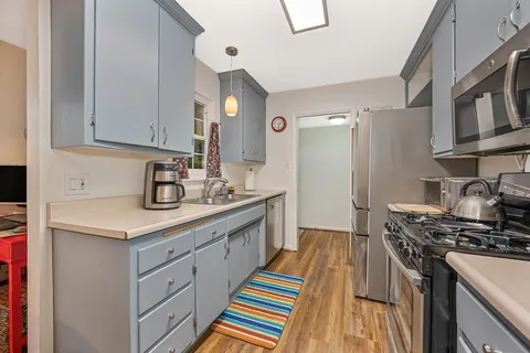 a kitchen with stainless steel appliances granite countertop a stove and a sink