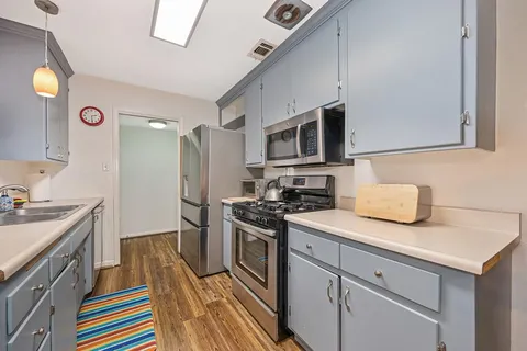 a kitchen with a sink stove and refrigerator
