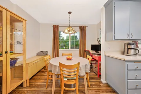 a dining room with furniture window and outside view