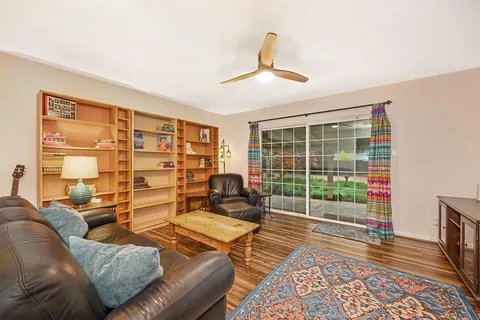 a living room with furniture and a floor to ceiling window
