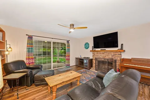 a living room with furniture a fireplace and a flat screen tv