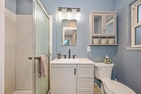 a bathroom with a toilet sink and mirror
