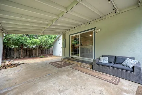 a outdoor space with patio furniture and floor to ceiling window