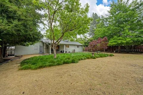 a front view of a house with a yard and a garage