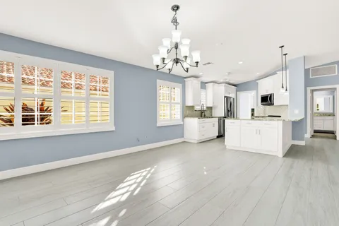 a view of a kitchen with microwave and cabinets