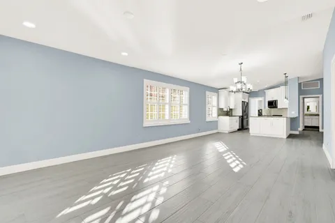 a view of kitchen with livingroom and wooden floor