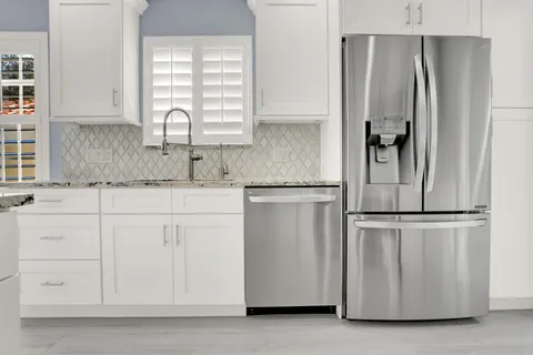 a kitchen with appliances cabinets and a window