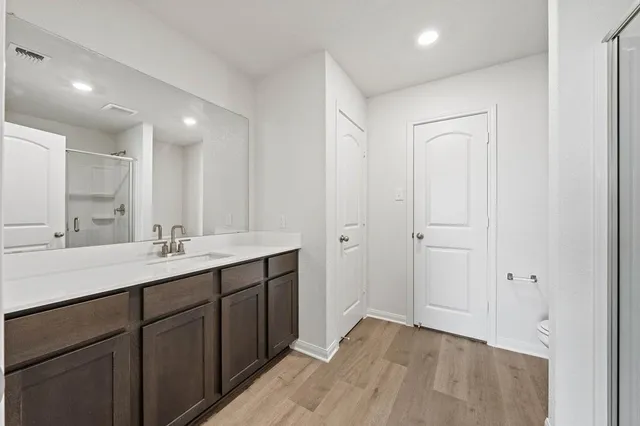 a bathroom with a double vanity sink and a mirror