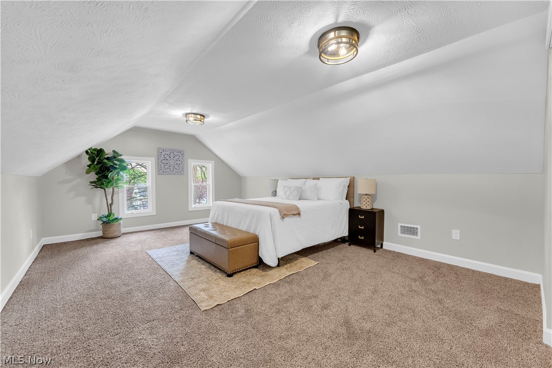18155 Libby Road Maple Heights, OH 44137 - Photo 21 of 32 Carpeted room featuring sloped ceilings, two window placements, and recessed lighting fixtures