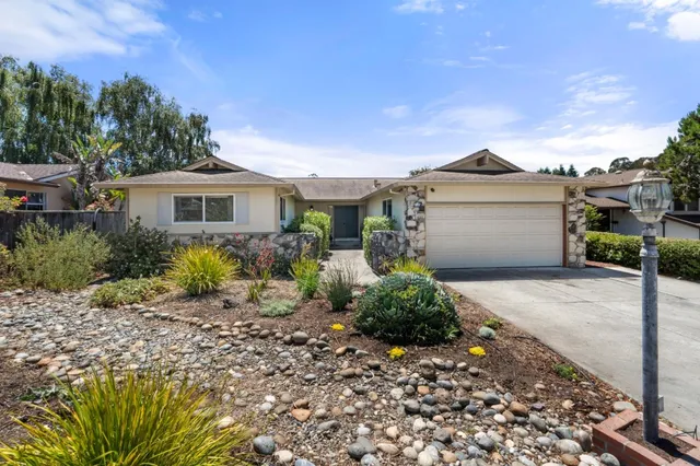 a front view of a house with garden