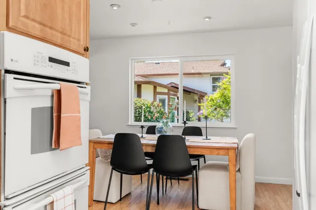 a view of a dining room with furniture and a potted plant