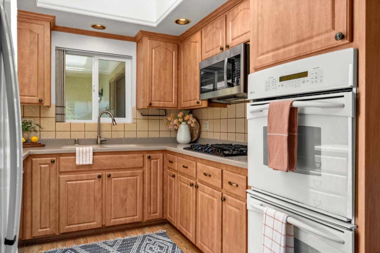 221 Segre Place Santa Cruz, CA 95060 - Photo 13 of 41 a kitchen with stainless steel appliances granite countertop a sink and cabinets