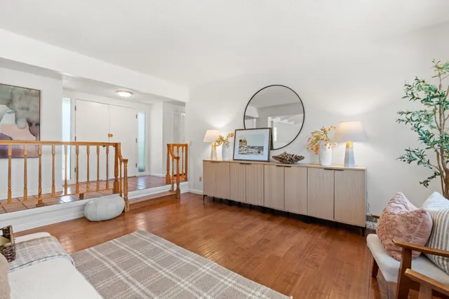 a living room with furniture and a wooden floor