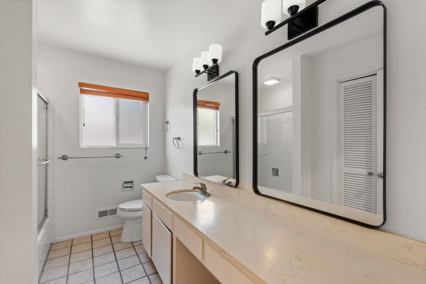 221 Segre Place Santa Cruz, CA 95060 - Photo 24 of 41 a bathroom with a granite countertop sink a toilet and mirror