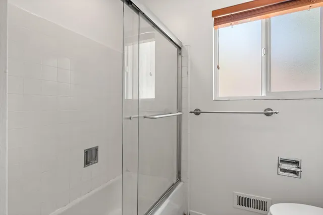 a bathroom with a shower and a toilet