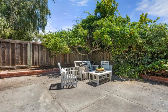 a view of a chairs and tables in the back yard of the house