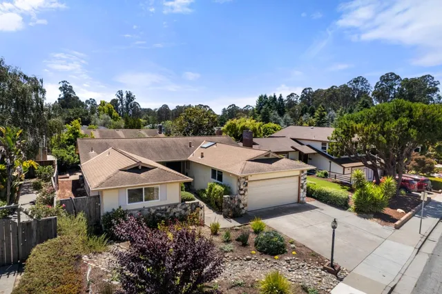 an aerial view of multiple houses with a yard