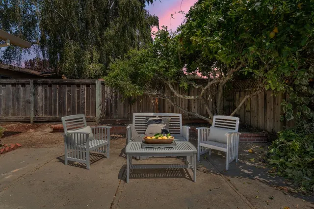 a view of a chairs and tables in the back yard of the house