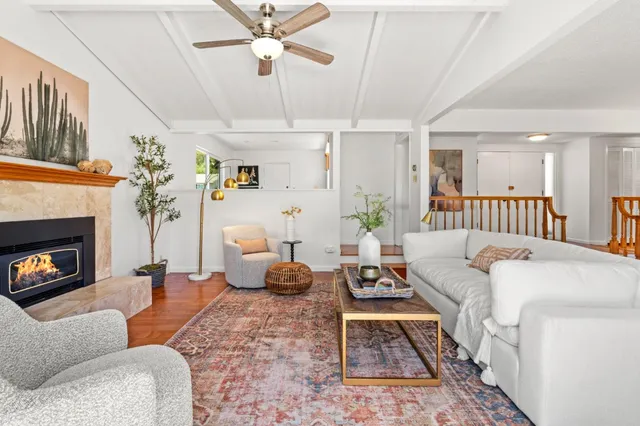 a living room with furniture fireplace and a fireplace