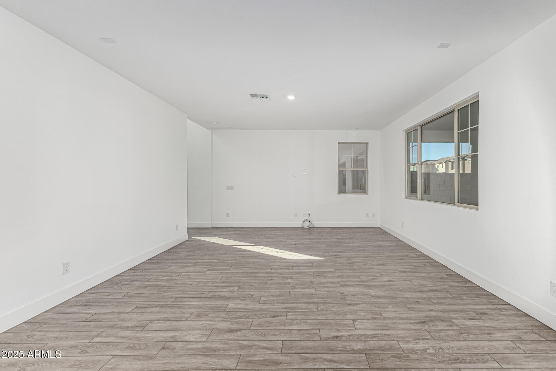 21494 East Timberline Road Queen Creek, AZ 85142 - Photo 6 of 32 a view of empty room with wooden floor and fan