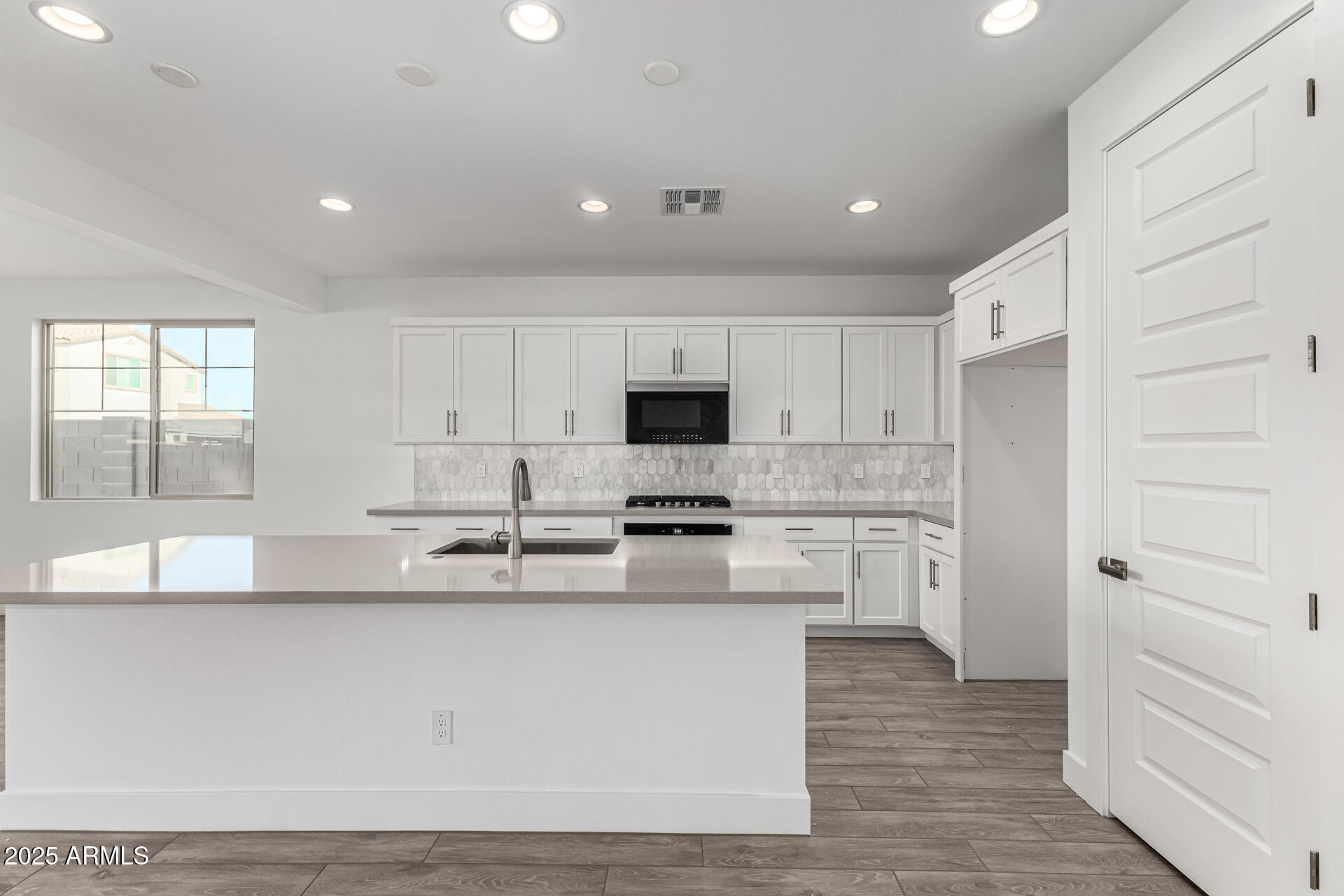 21494 East Timberline Road Queen Creek, AZ 85142 - Photo 9 of 32 a kitchen with stainless steel appliances granite countertop a refrigerator and a stove top oven
