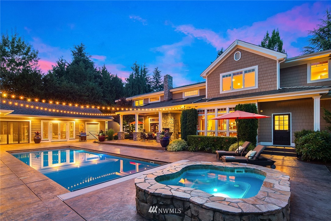 a view of a house with swimming pool and sitting area