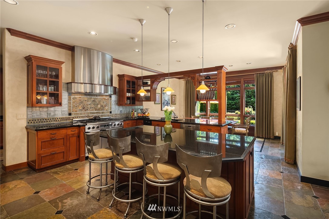 3114 220th Street Southeast Bothell, WA 98021 - Photo 14 of 39 a kitchen with stainless steel appliances granite countertop a stove a sink and a dining table