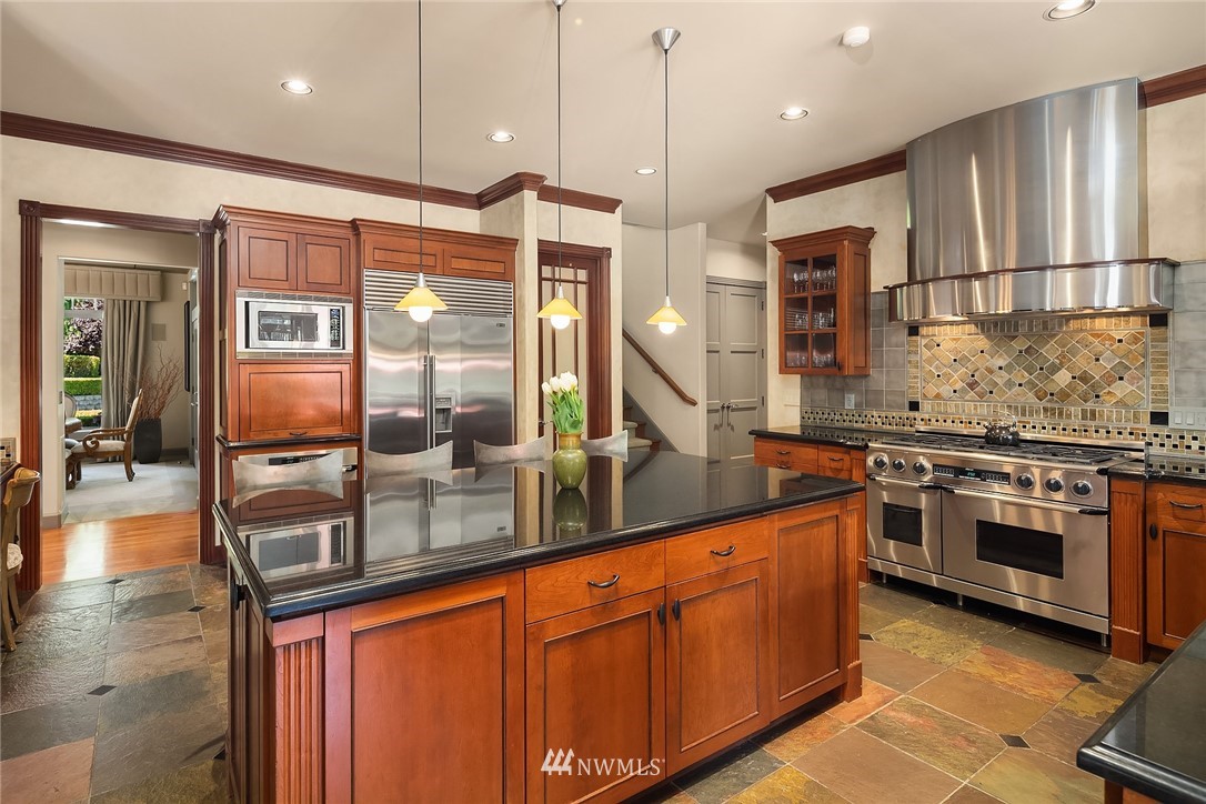 3114 220th Street Southeast Bothell, WA 98021 - Photo 16 of 39 a kitchen with stainless steel appliances granite countertop a stove a sink and a refrigerator
