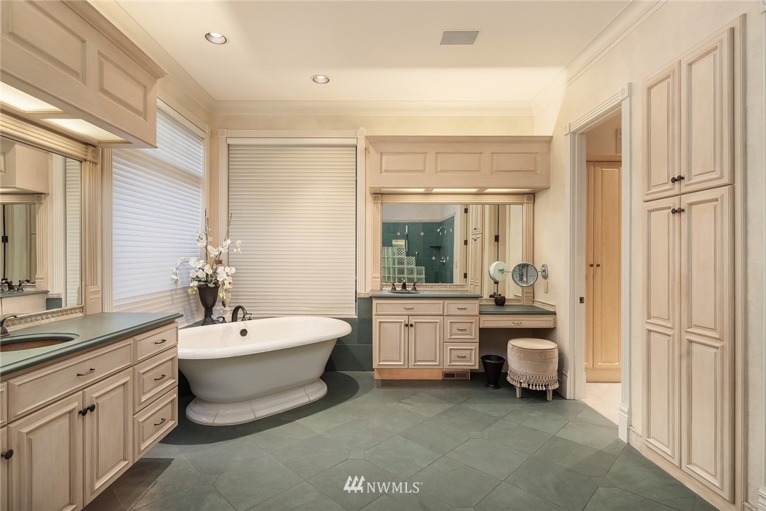 3114 220th Street Southeast Bothell, WA 98021 - Photo 19 of 39 a bathroom with a double vanity sink a large mirror and a bathtub
