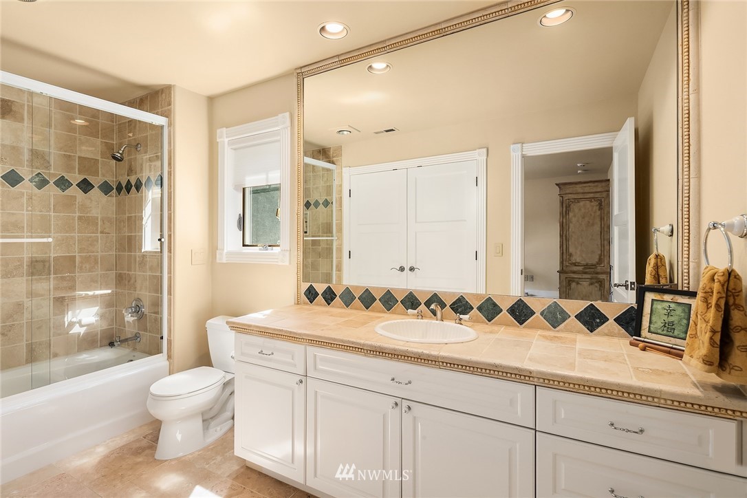 3114 220th Street Southeast Bothell, WA 98021 - Photo 22 of 39 a bathroom with a sink a toilet and shower