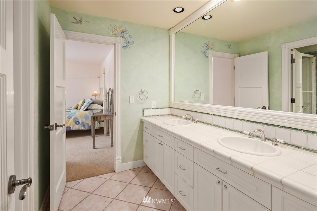 3114 220th Street Southeast Bothell, WA 98021 - Photo 24 of 39 a en suite bathroom with a double vanity sink and a mirror
