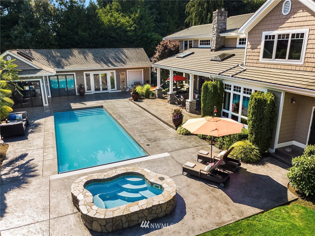3114 220th Street Southeast Bothell, WA 98021 - Photo 30 of 39 a view of a white house with chairs in patio