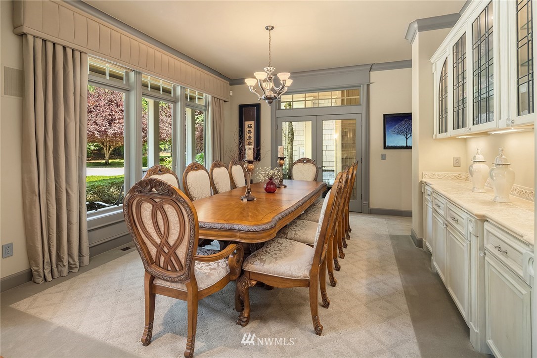 3114 220th Street Southeast Bothell, WA 98021 - Photo 9 of 39 a dining room with furniture a chandelier and window