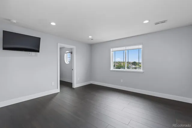 a view of a house with a big yard and large trees
