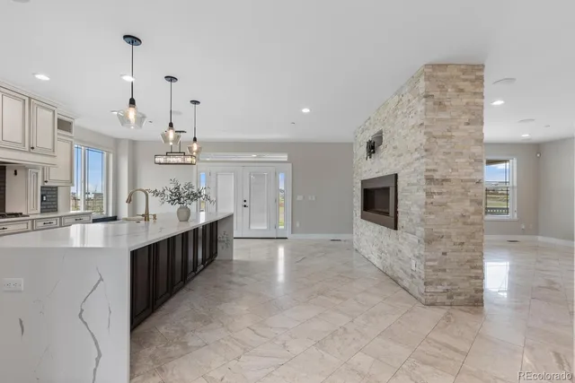 a view of a big room with kitchen and windows