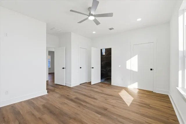 a view of hallway with wooden floor
