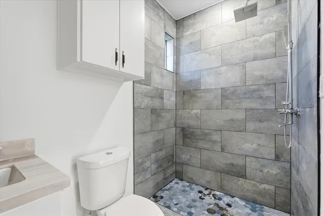 a bathroom with a toilet sink and shower