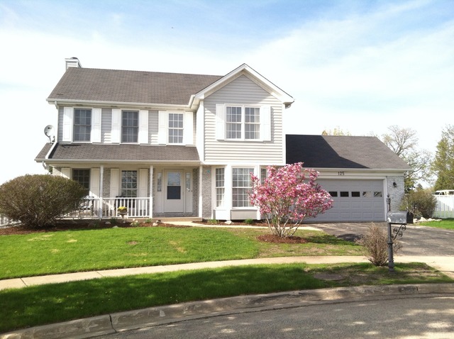 125 Cobblestone Court DeKalb, IL 60115 - Photo 1 of 25 a front view of a house with a yard and garage