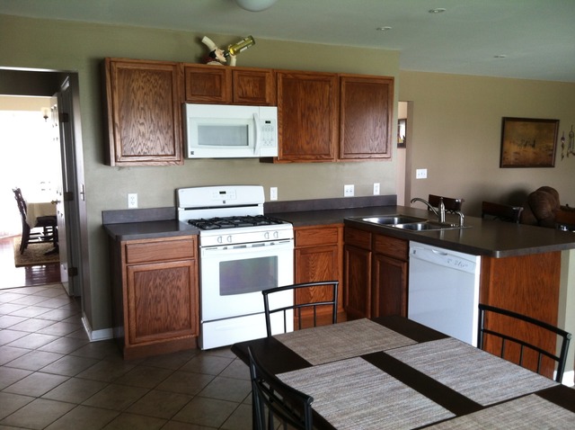 125 Cobblestone Court DeKalb, IL 60115 - Photo 6 of 25 a kitchen with a stove a sink and a microwave