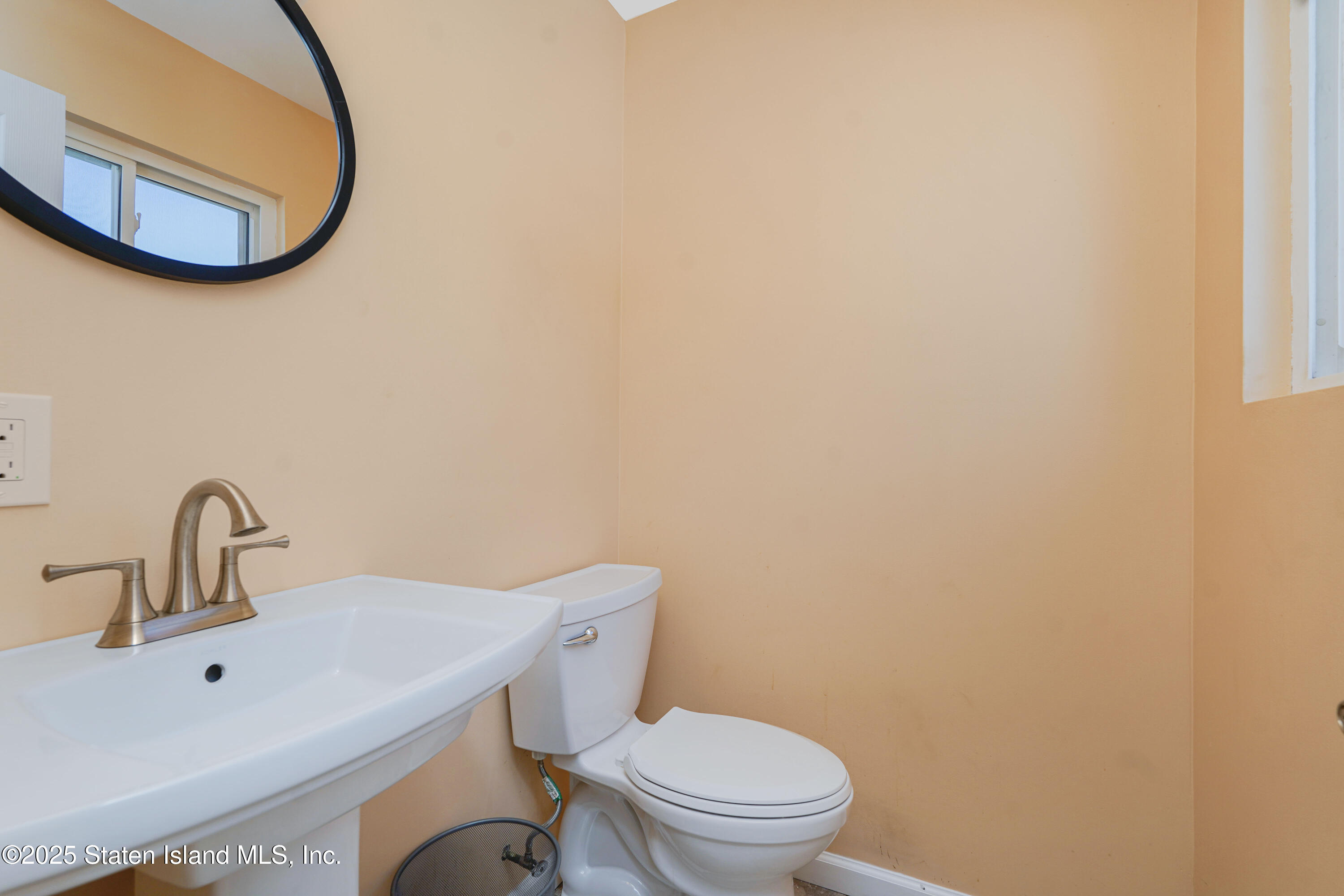80 Gold Avenue Staten Island, NY 10312 - Photo 16 of 33 a bathroom with a toilet sink and mirror