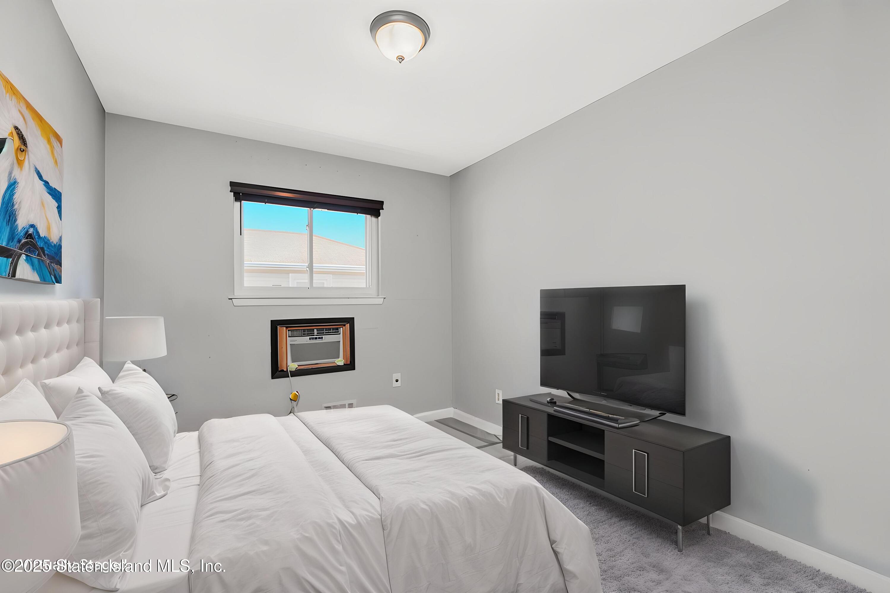 80 Gold Avenue Staten Island, NY 10312 - Photo 20 of 33 a bedroom with a bed and a flat screen tv