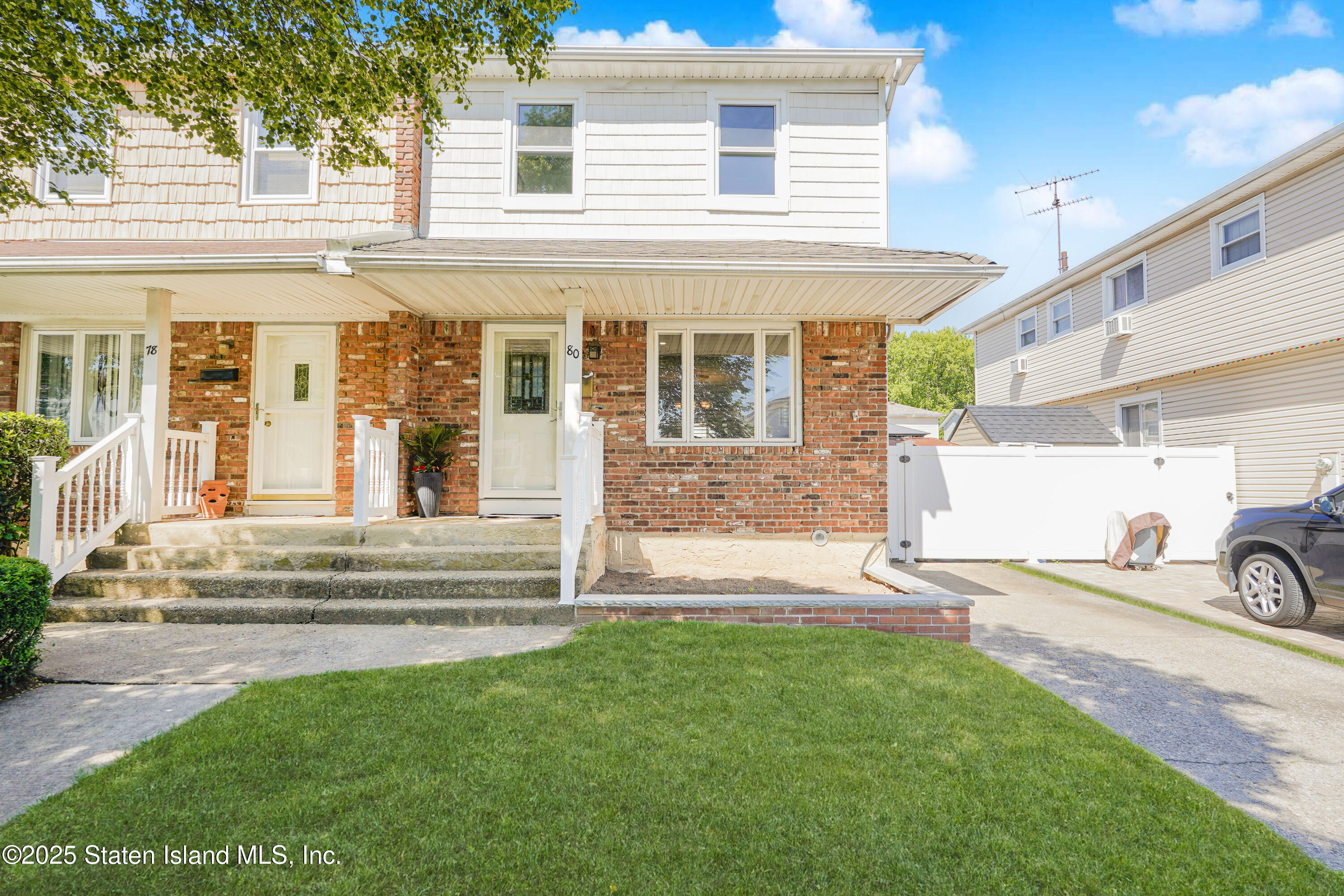 80 Gold Avenue Staten Island, NY 10312 - Photo 2 of 33 a front view of a house with a yard and garage