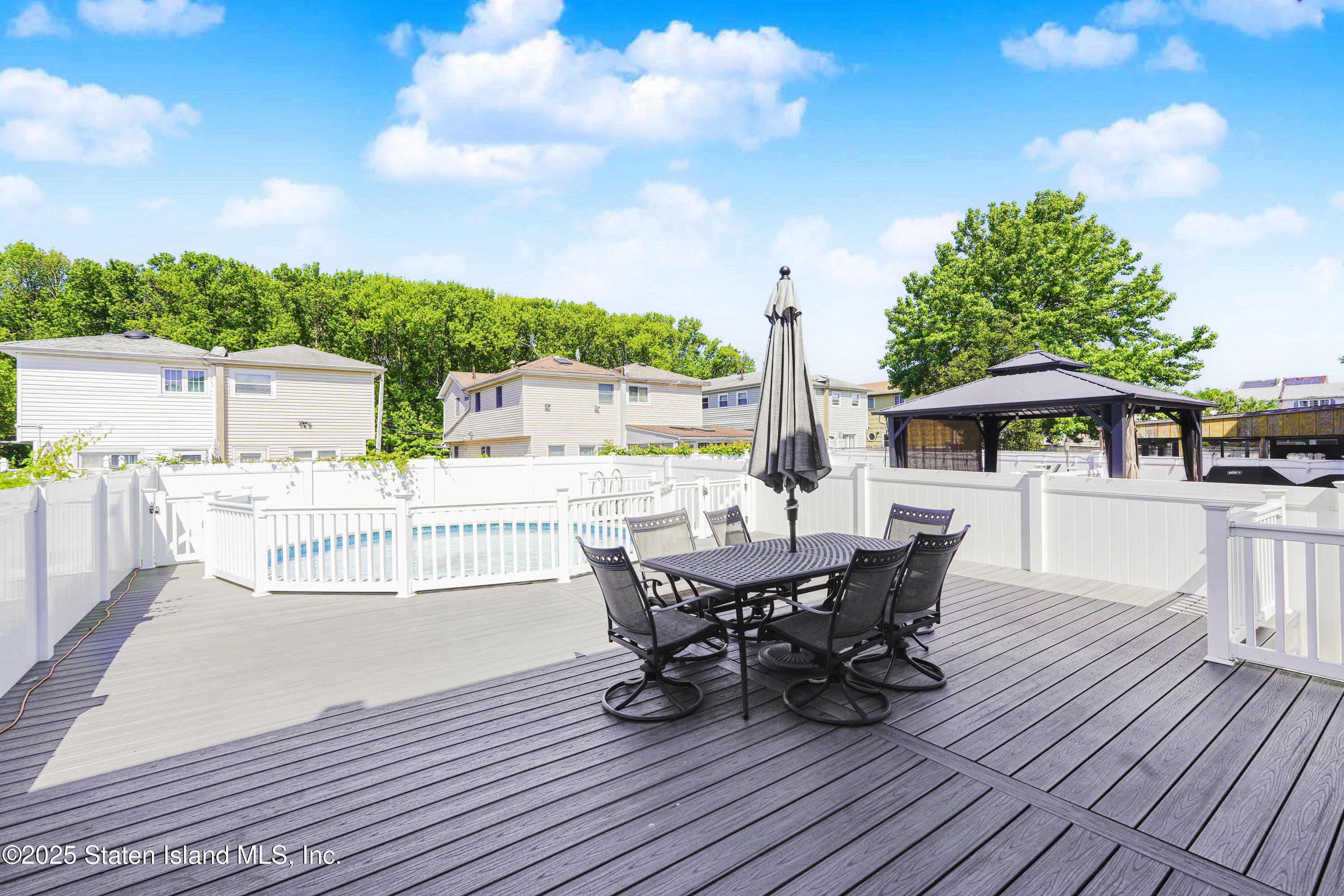 80 Gold Avenue Staten Island, NY 10312 - Photo 29 of 33 a balcony with wooden floor table and chairs