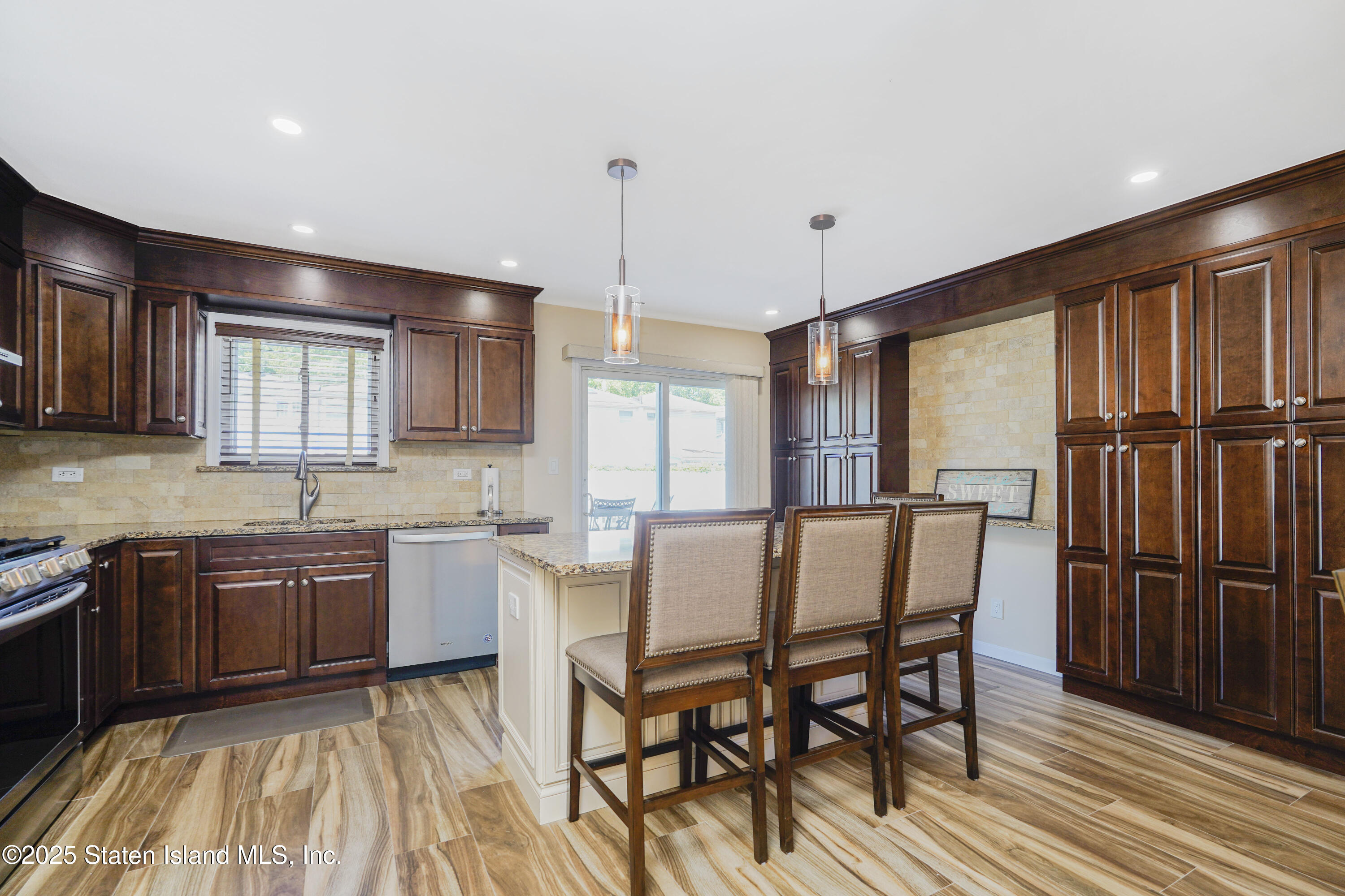 80 Gold Avenue Staten Island, NY 10312 - Photo 6 of 33 a kitchen with a table chairs stove and cabinets