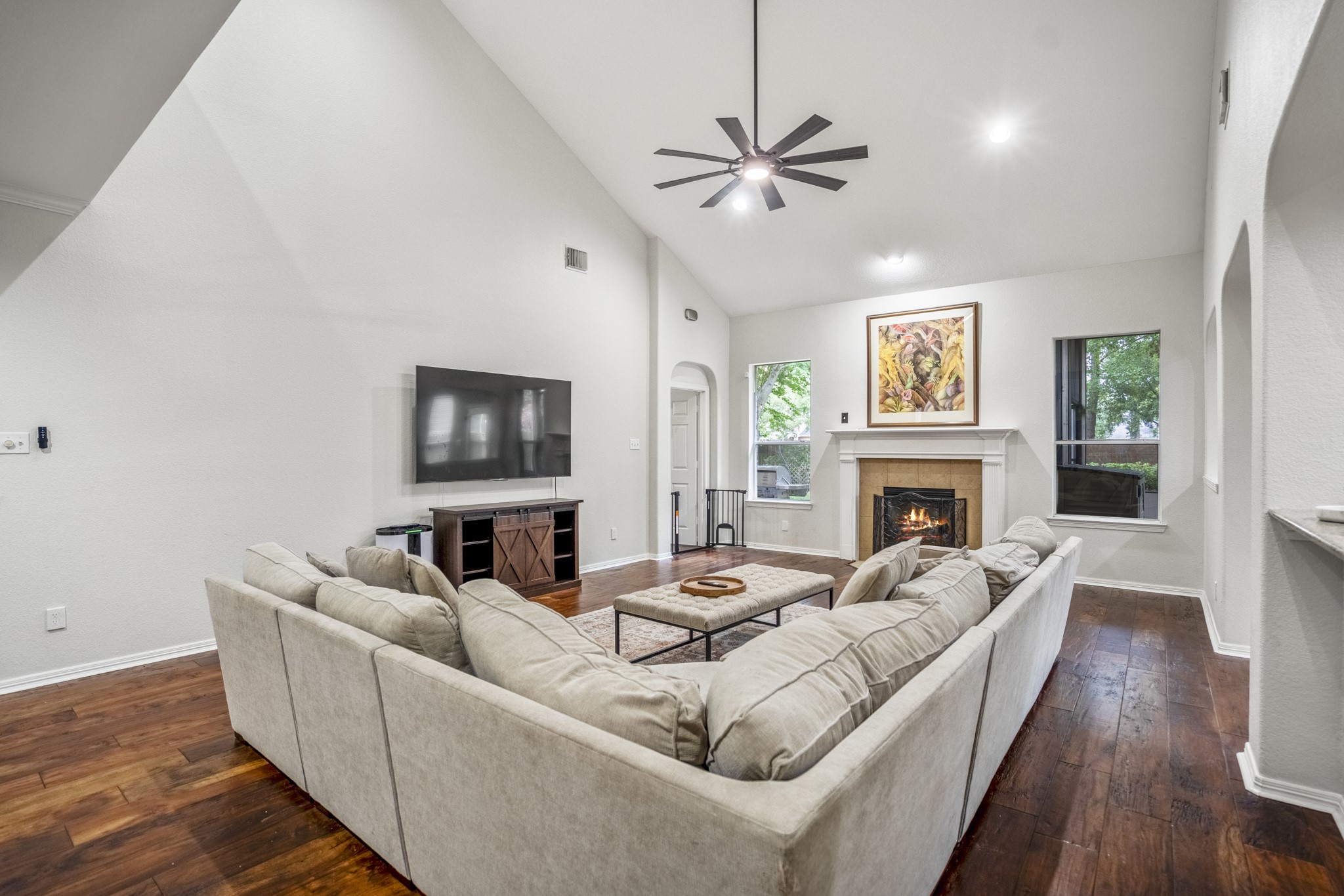 10410 Pitcataway Drive Spring, TX 77379 - Photo 10 of 48 The fireplace serves as an anchor and focal point creating a warm atmosphere. With its generous proportions and tranquil garden views, this space offers a peaceful retreat from the bustle of daily life.